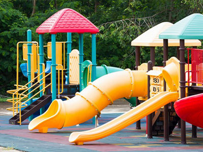 Colorful outdoor playground equipment with plastic slides and climbing structures made from durable consumer-grade plastics.
