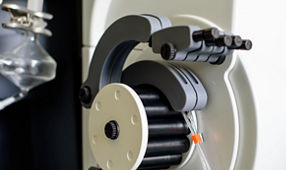 Peristaltic pump with plastic tubes and rollers moving.