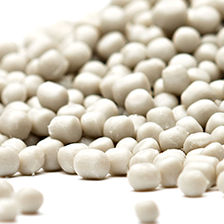 Close up of beige natural polyolefin pellets