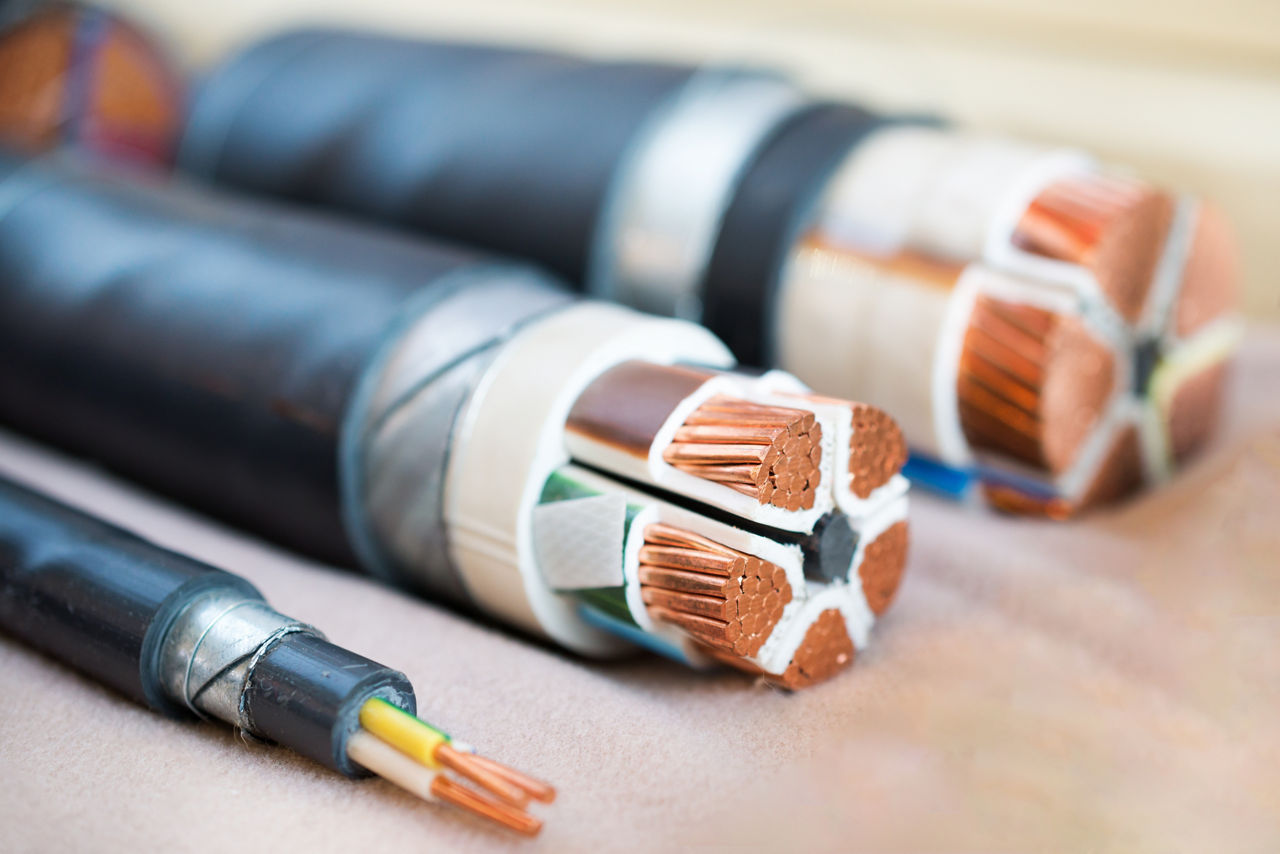 Cross section of high-voltage cable. Thick copper veins are surrounded by a thick layer of polymer insulation.