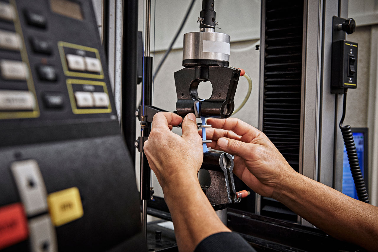 Hands testing strech of a TPE extruded material in a lab