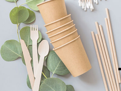 eco natural paper cups, straws, toothbrush flat lay on gray background. sustainable lifestyle concept. zero waste, plastic free items. stop plastic pollution. Top view, overhead, template, Mockup.