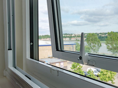 Close-up of a newly installed double glazing system installed in an apartment. Outside can be seen a semi rural location with a distant river in the United Kingdom.