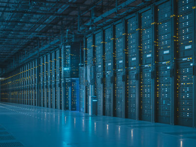 a massice data center faicility storage room with a worker walking through 
